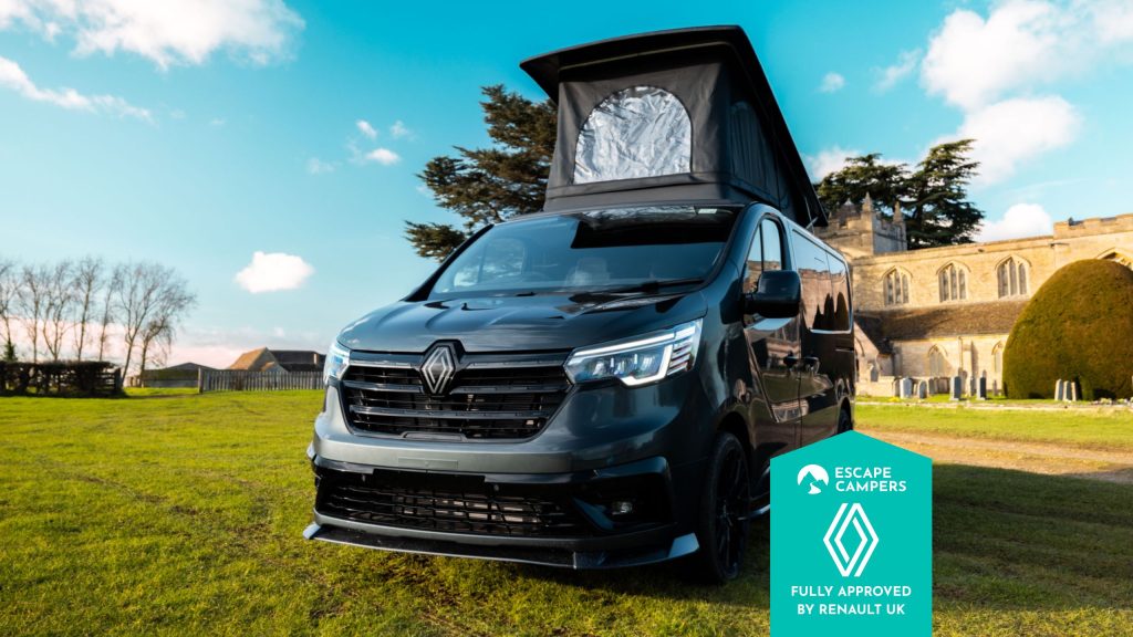 Escape Crusader Renault Trafic campervan in front of a country house with the Fully Approved by Renault UK badge