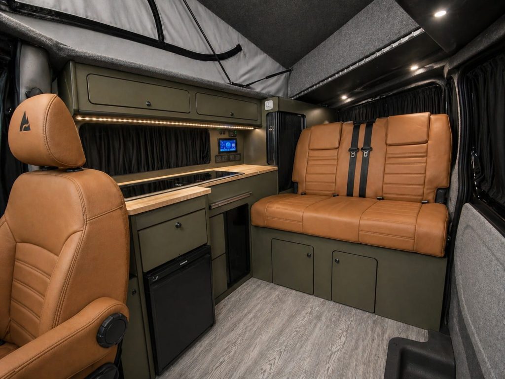 Interior of an Escape Crusader Renault Trafic campervan with the pop top raised and leather rear seat bed
