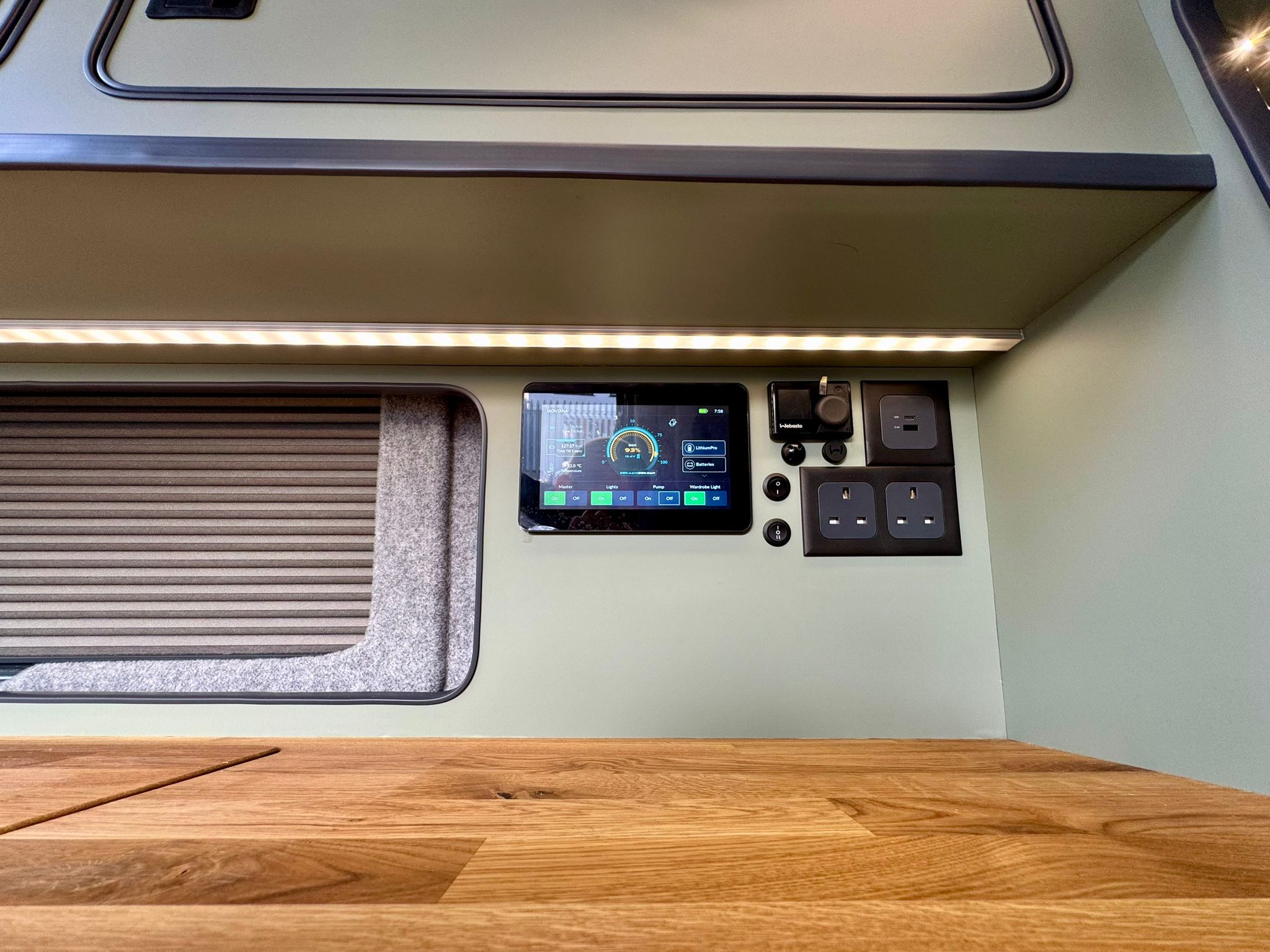 Webasto diesel heater controller next to the touch screen control panel and sockets in an Escape Breeze Plus campervan