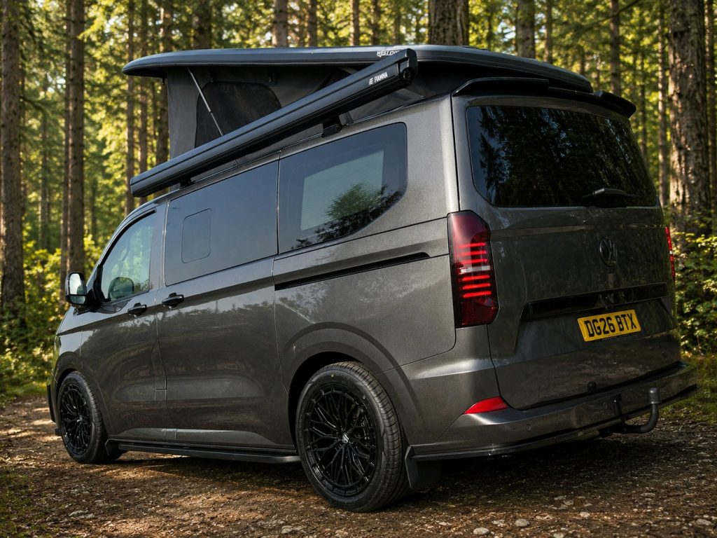 Rear three quarter view of a VW T7 Escape Breeze Plus campervan with the pop top canvas raised