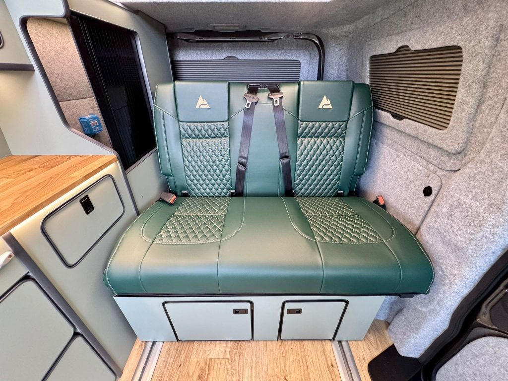 Two seat RIB rock and roll bed with built in seat belts in an Escape Breeze Plus VW T7 campervan